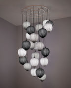 A custom installation of over twenty Dippa pendants in smoke, silver, and Coal.  A floating cluster that is both spiral and constellation, guiding the currents of a stairway.