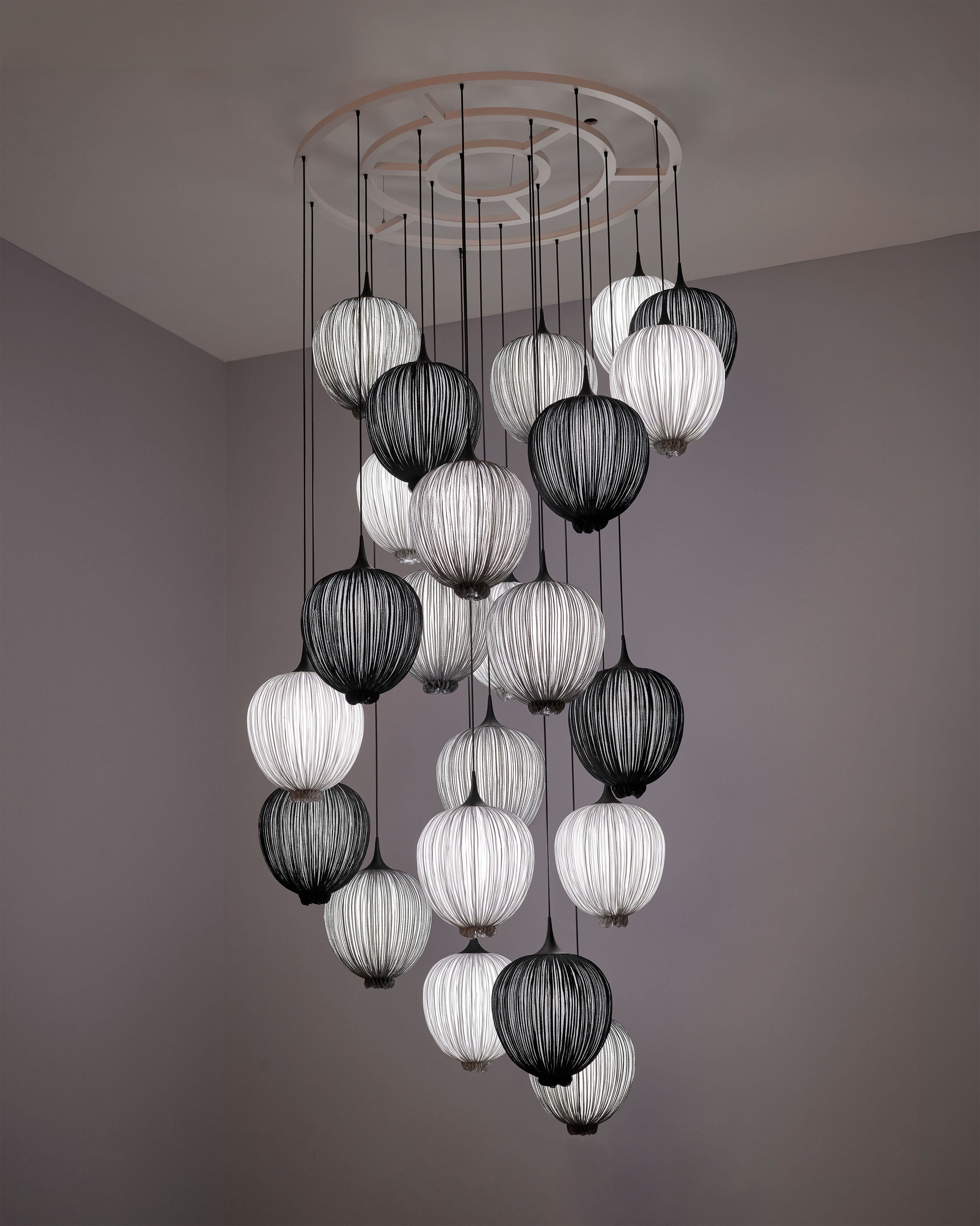 A custom installation of over twenty Dippa pendants in smoke, silver, and Coal.  A floating cluster that is both spiral and constellation, guiding the currents of a stairway.