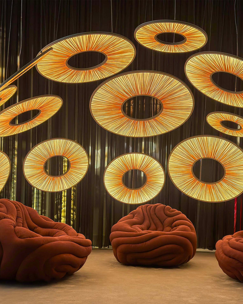 Manhattan Pendant light installation Euroluce 2025 (sizes 60,90,120cm) with Gladis Armchair